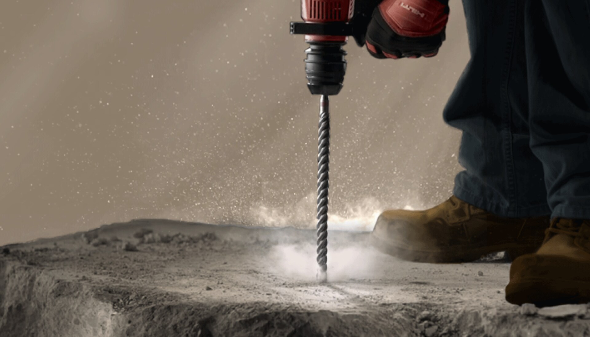 Tool drilling into cement and stirring up dust